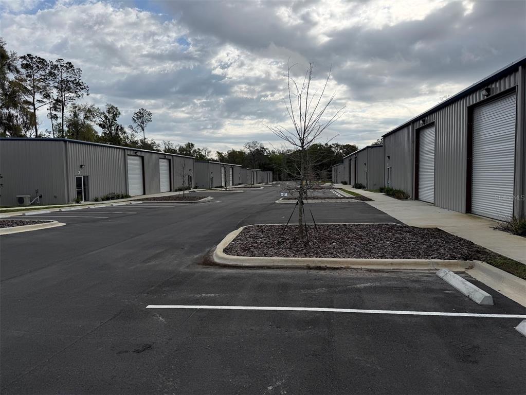 An exterior view of a commercial warehouse complex with multiple metal buildings and paved parking — 5741 S PINE AVENUE, OCALA, FL