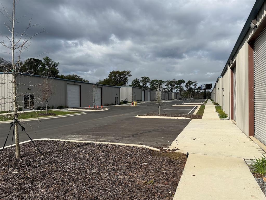 An exterior view of a commercial warehouse complex with metal buildings and paved parking — 5741 S PINE AVENUE, OCALA, FL