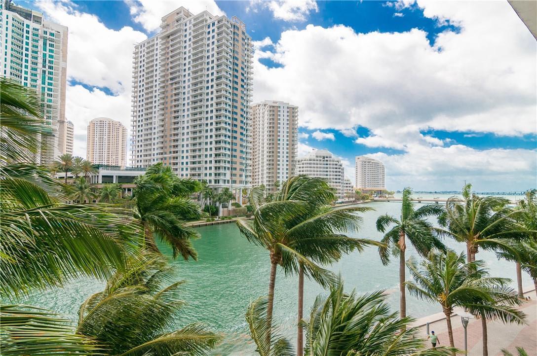 A view of a waterfront canal lined with palm trees and tall residential apartment buildings — 465 Brickell Avenue # 419, Miami FL 33131, MIAMI, FL