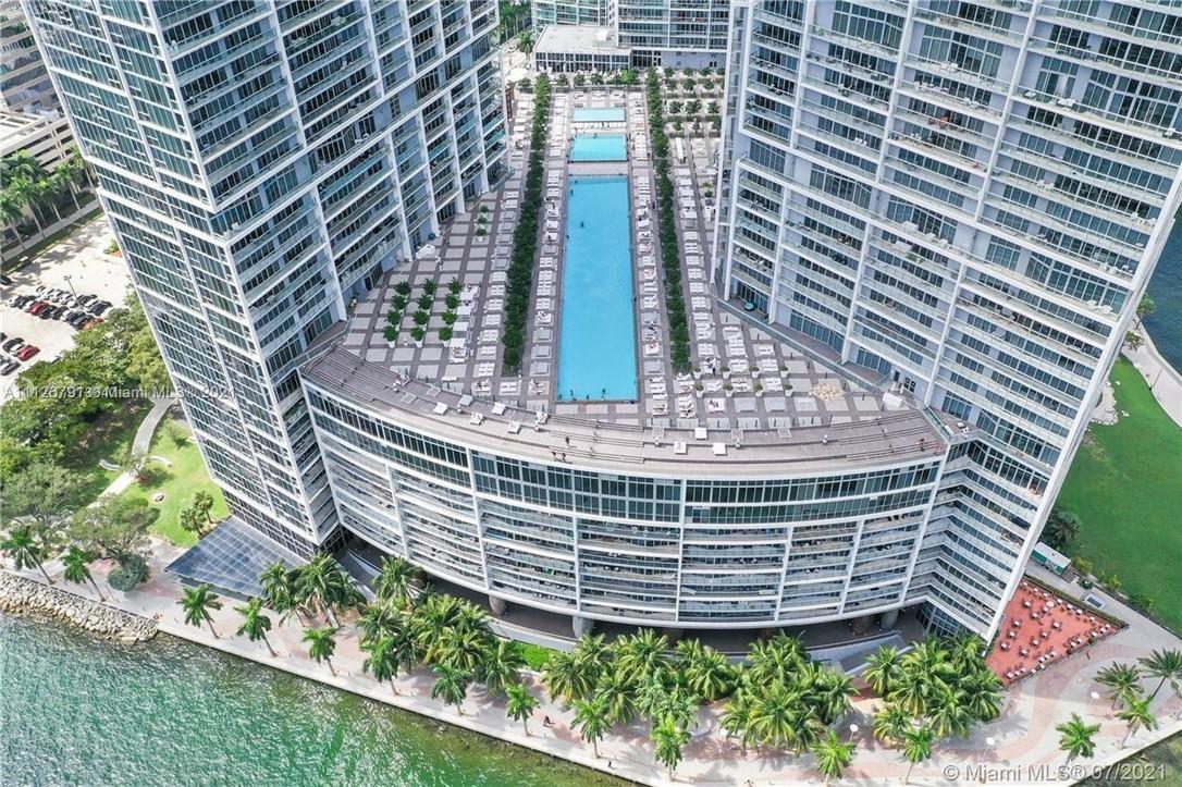An aerial view shows a high-rise building with a large outdoor pool deck — 465 Brickell Avenue # 419, Miami FL 33131, MIAMI, FL