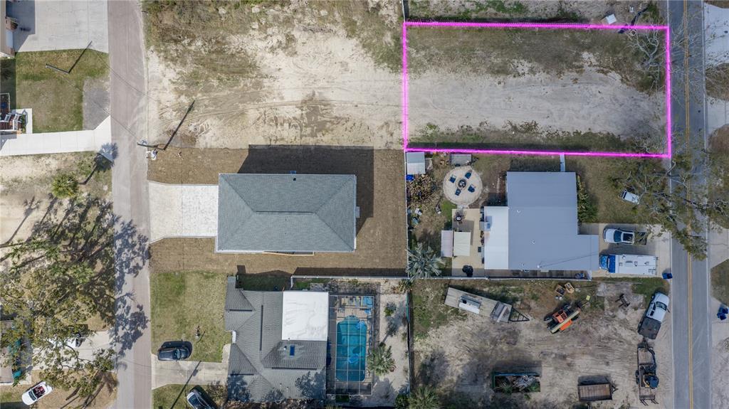 An aerial view shows a vacant rectangular lot outlined in pink next to existing houses — MAPLEWOOD DRIVE, HERNANDO BEACH, FL