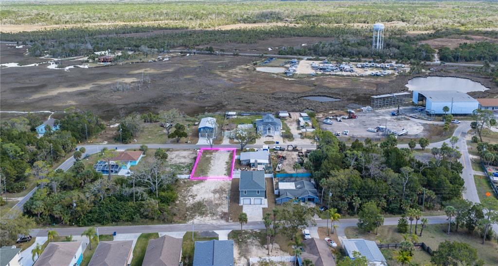 An aerial view shows a vacant rectangular lot outlined in pink within a residential neighborhood — MAPLEWOOD DRIVE, HERNANDO BEACH, FL