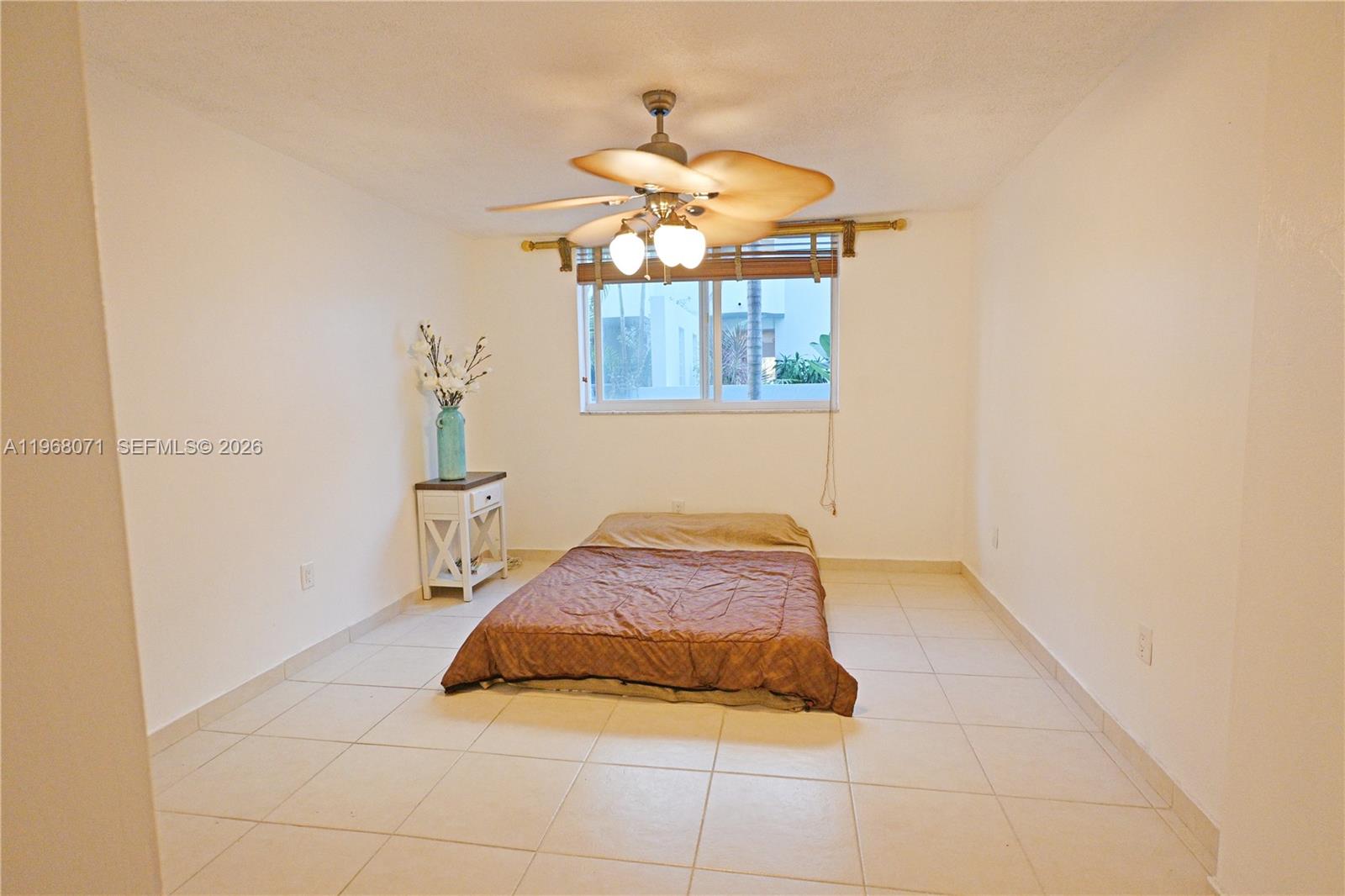 A bedroom features a mattress on the floor, a small side table, and tiled flooring — 947 Lenox Ave # 203, Miami Beach FL 33139, MIAMI BEACH, FL
