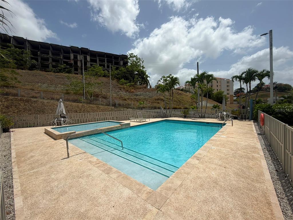 A rectangular swimming pool with an attached spa sits on a concrete deck outdoors — CAMINITO ALTO CARR 189, GURABO, PR