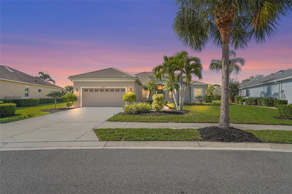 A single-story suburban house with a two-car garage, palm trees, and a manicured lawn — 357 MARSH CREEK ROAD, VENICE, FL