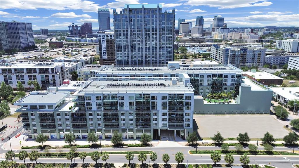 An aerial view of a multi-story apartment complex with a large parking lot nearby — 912 CHANNELSIDE DRIVE UNIT 2805, TAMPA, FL