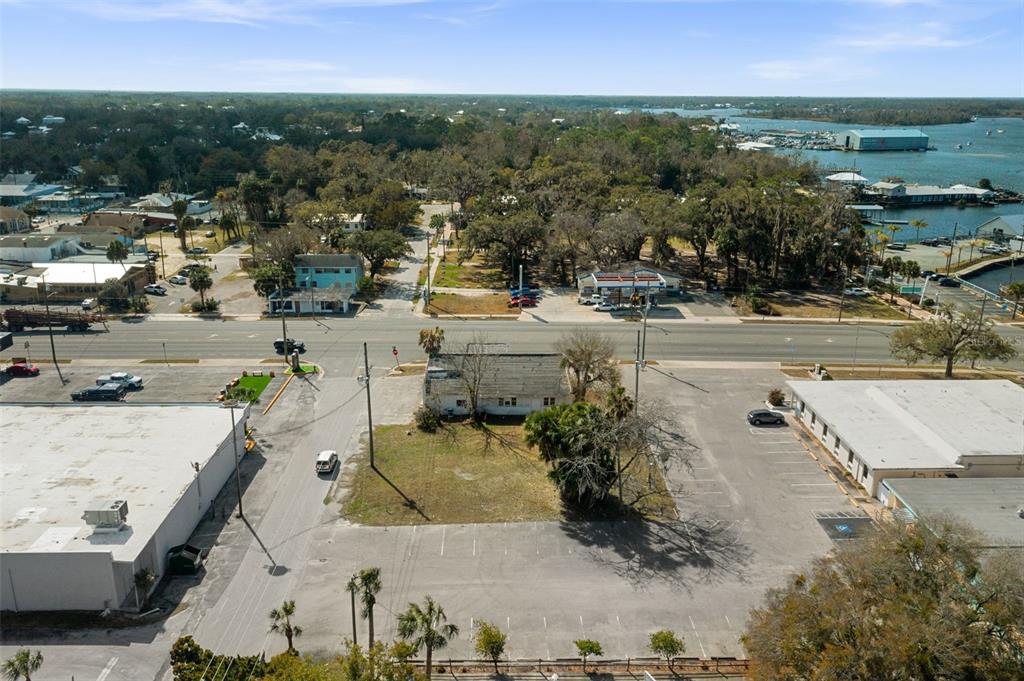 An aerial view shows a small building on a lot surrounded by parking lots — 103 NW US HIGHWAY 19, CRYSTAL RIVER, FL
