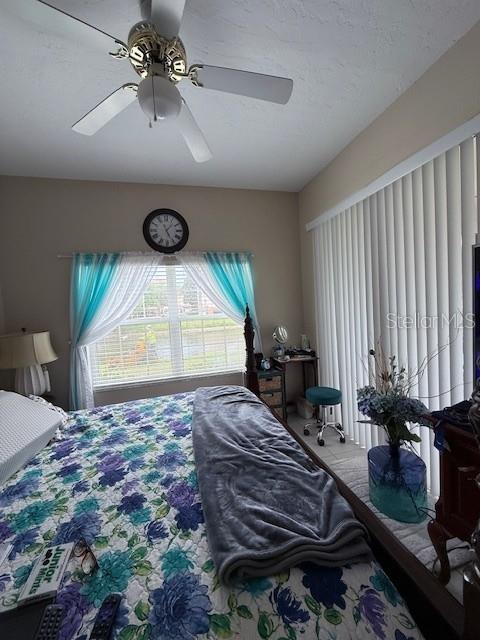 A living room and dining area feature tile flooring, a ceiling fan, and neutral walls — 4220 CENTRAL SARASOTA PARKWAY UNIT 1215, SARASOTA, FL