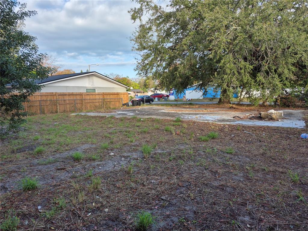 A vacant residential lot features a concrete slab foundation and a large mature tree — 7116 DIPAOLA DRIVE, HUDSON, FL