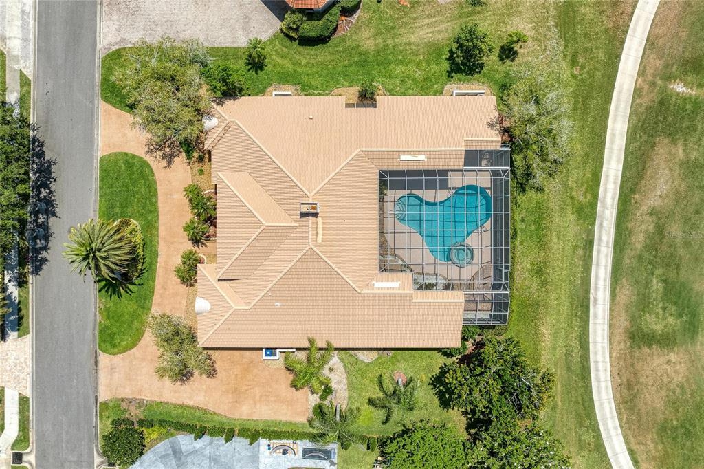 An aerial view shows a house with a tiled roof, a screened pool, and landscaping — 4268 LAS PALMAS WAY, SARASOTA, FL