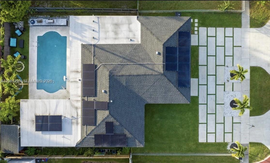 An aerial view shows a house with a pool, patio, solar panels, and a paved driveway — 16100 NE 9th Ct, North Miami Beach FL 33162, NORTH MIAMI BEACH, FL