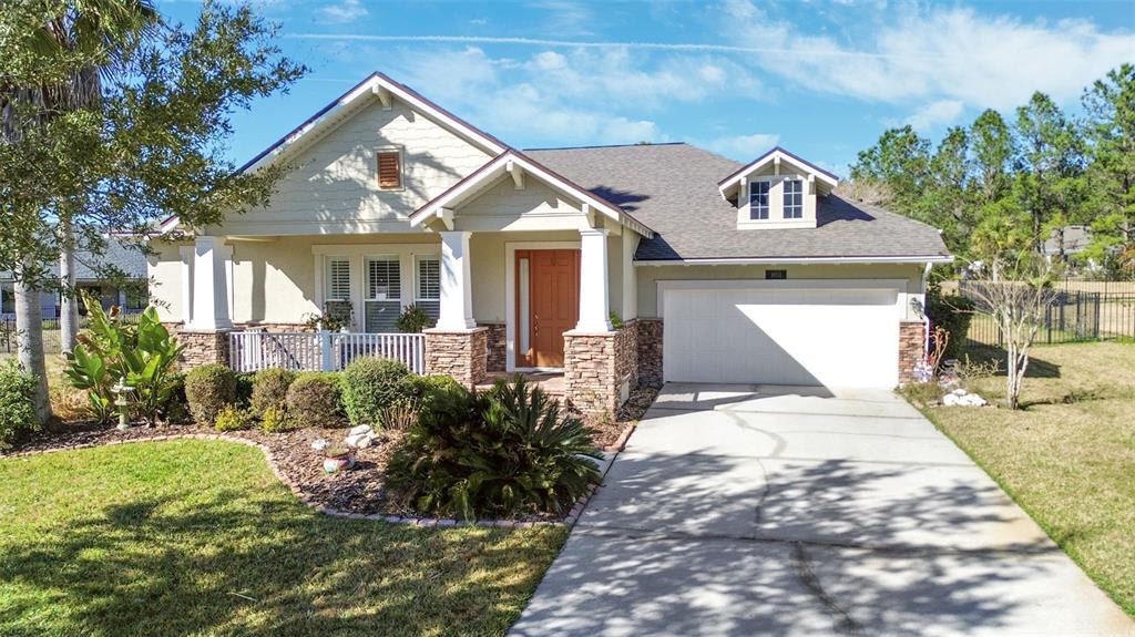 A single-story house with a stone-accented facade, a front porch, and an attached garage — 19531 MOSSY OAK COURT, BROOKSVILLE, FL
