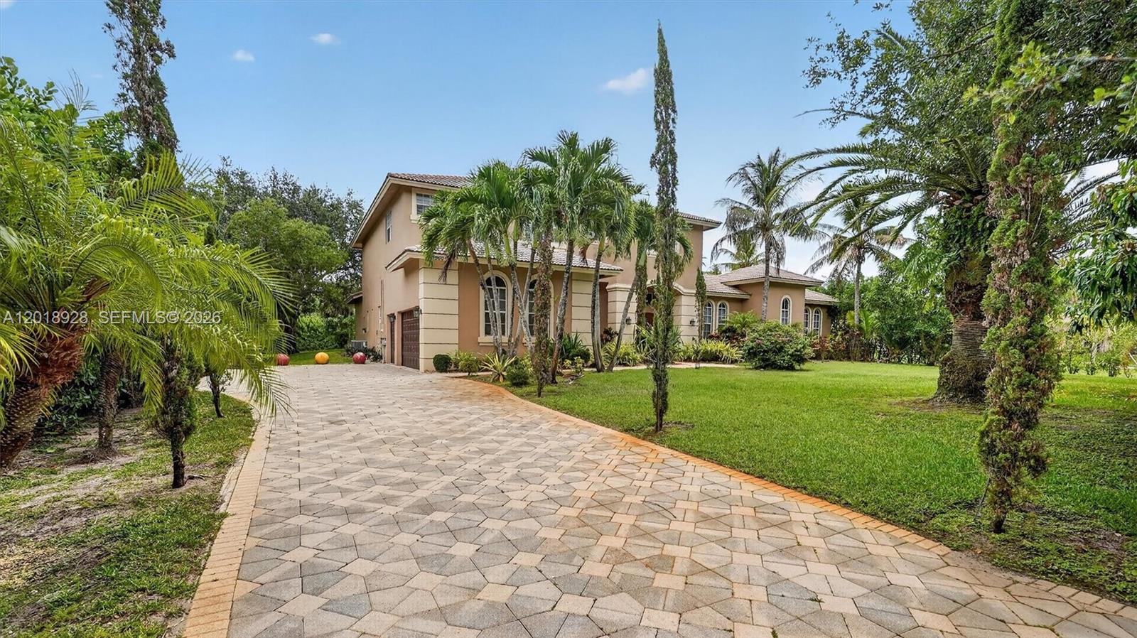 A two-story house with a paved driveway and palm trees in the front yard — 5960 NW 79th Way, Parkland FL 33067, PARKLAND, FL