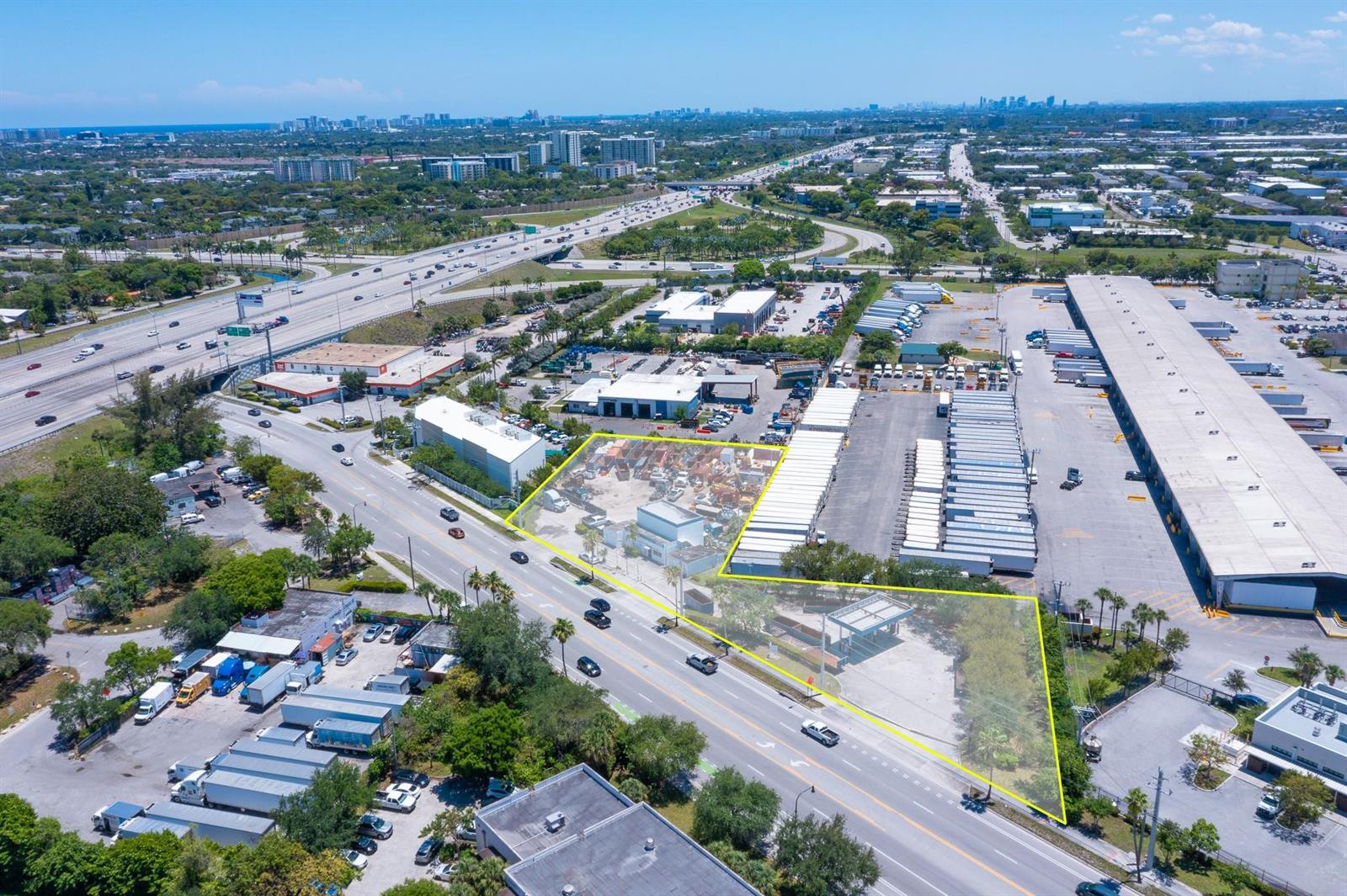 An aerial view shows a commercial property outlined in yellow next to a large warehouse — 1126 Dr Martin Luther King Jr Boulevard, Pompano Beach FL 33069, POMPANO BEACH, FL