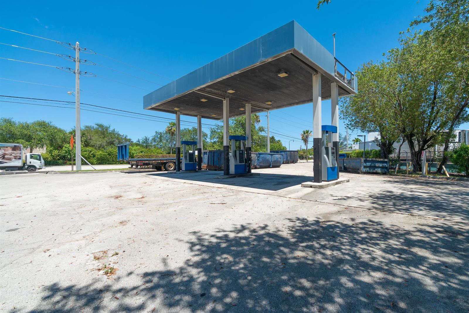 An outdoor gas station canopy stands over fuel pumps on a paved concrete lot — 1126 Dr Martin Luther King Jr Boulevard, Pompano Beach FL 33069, POMPANO BEACH, FL