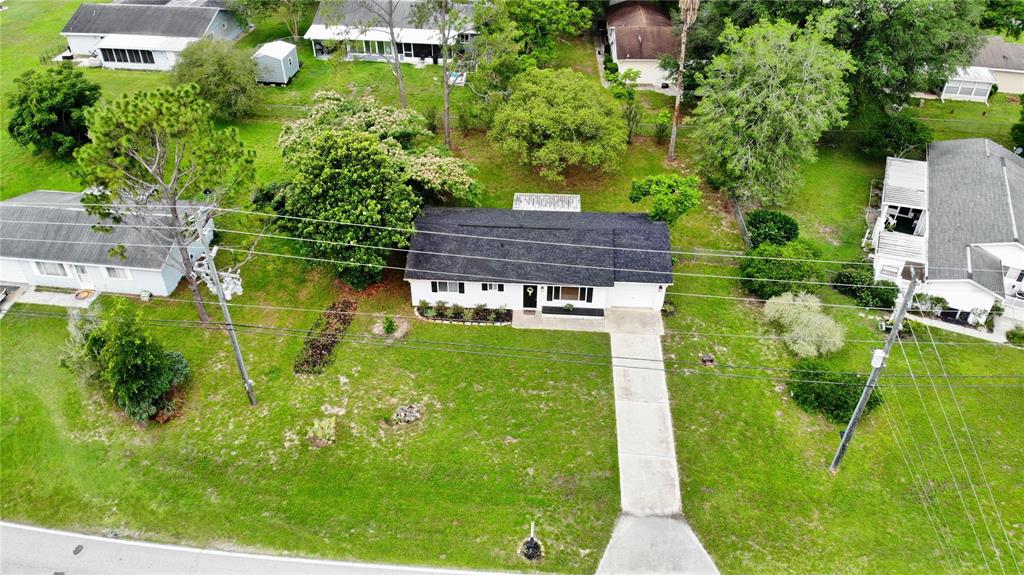 An aerial view shows a single-story house with a dark roof and a concrete driveway — 10740 SW 62ND AVENUE ROAD, OCALA, FL