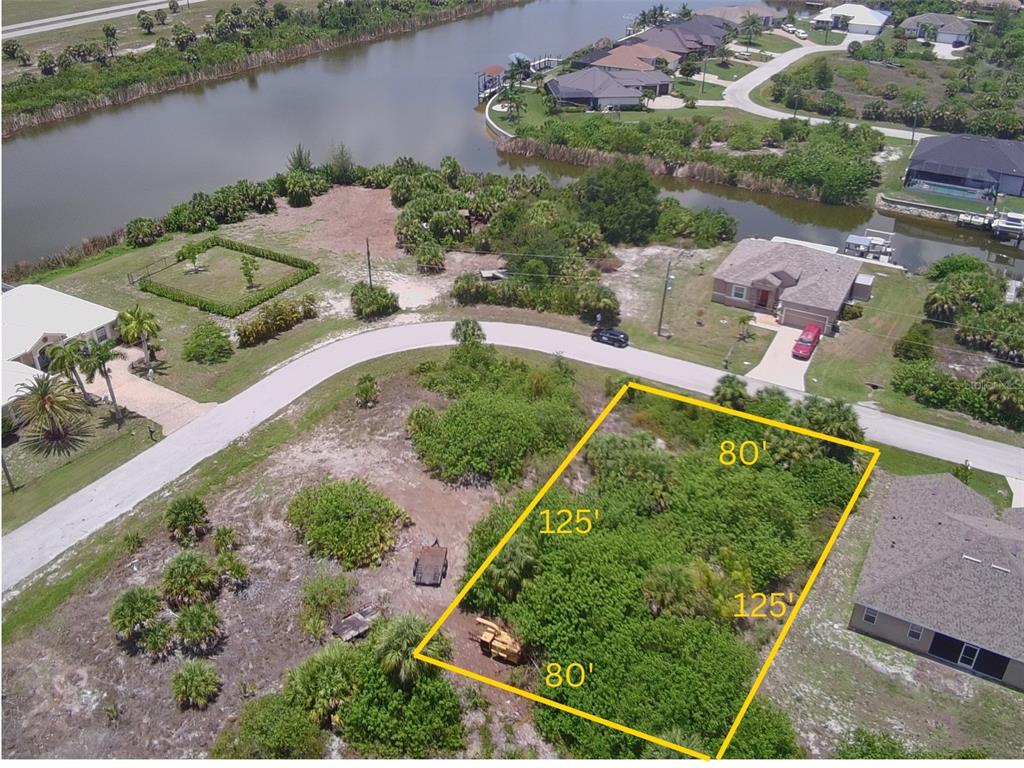 An aerial view shows a rectangular vacant lot marked with dimensions in a residential neighborhood — 10484 HARLINGEN STREET, PORT CHARLOTTE, FL