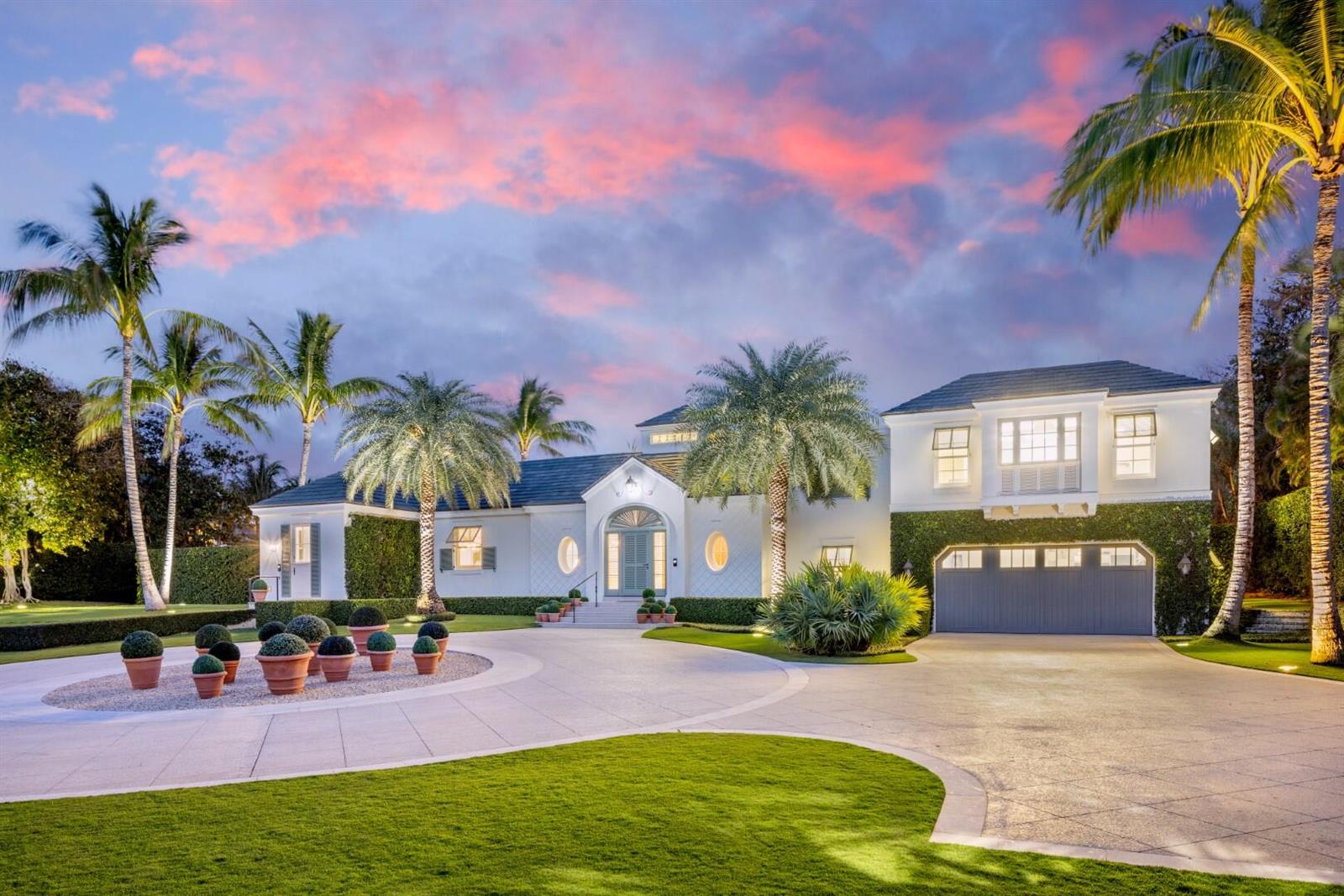 A white house with a circular driveway, palm trees, and a sunset sky — 710 S County Road, Palm Beach FL 33480, PALM BEACH, FL