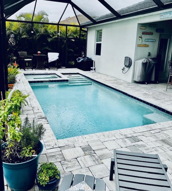 A single-story house with a landscaped front yard and palm trees at sunset — 15113 SPANISH POINT DRIVE, PORT CHARLOTTE, FL