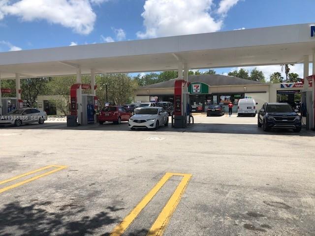 A 7-Eleven gas station with multiple parked cars under a large white canopy — Confidential, Kendall FL 33173, KENDALL, FL