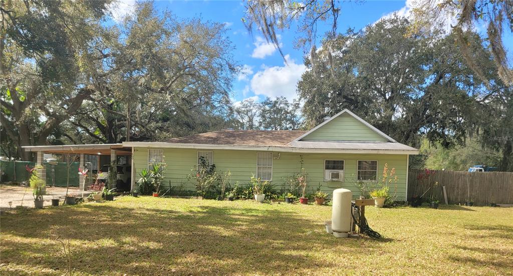 A light green, single-story house with a carport and a large, grassy front yard — 0 BUCKLEY DRIVE, KISSIMMEE, FL