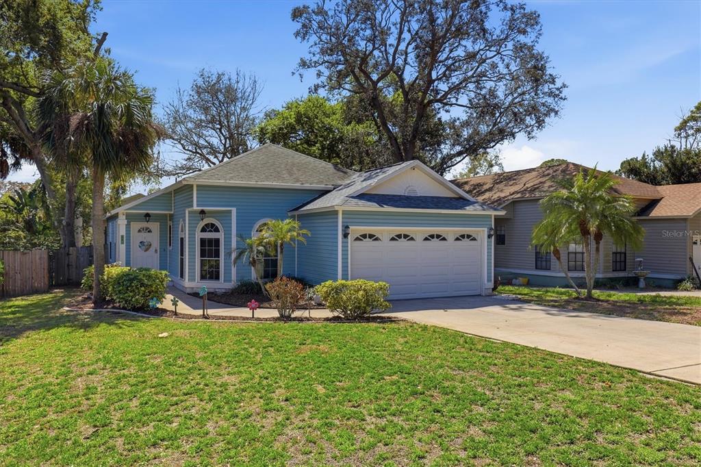 A blue single-story house with a two-car garage and a front lawn — 86 HIGHLAND ROAD, TARPON SPRINGS, FL
