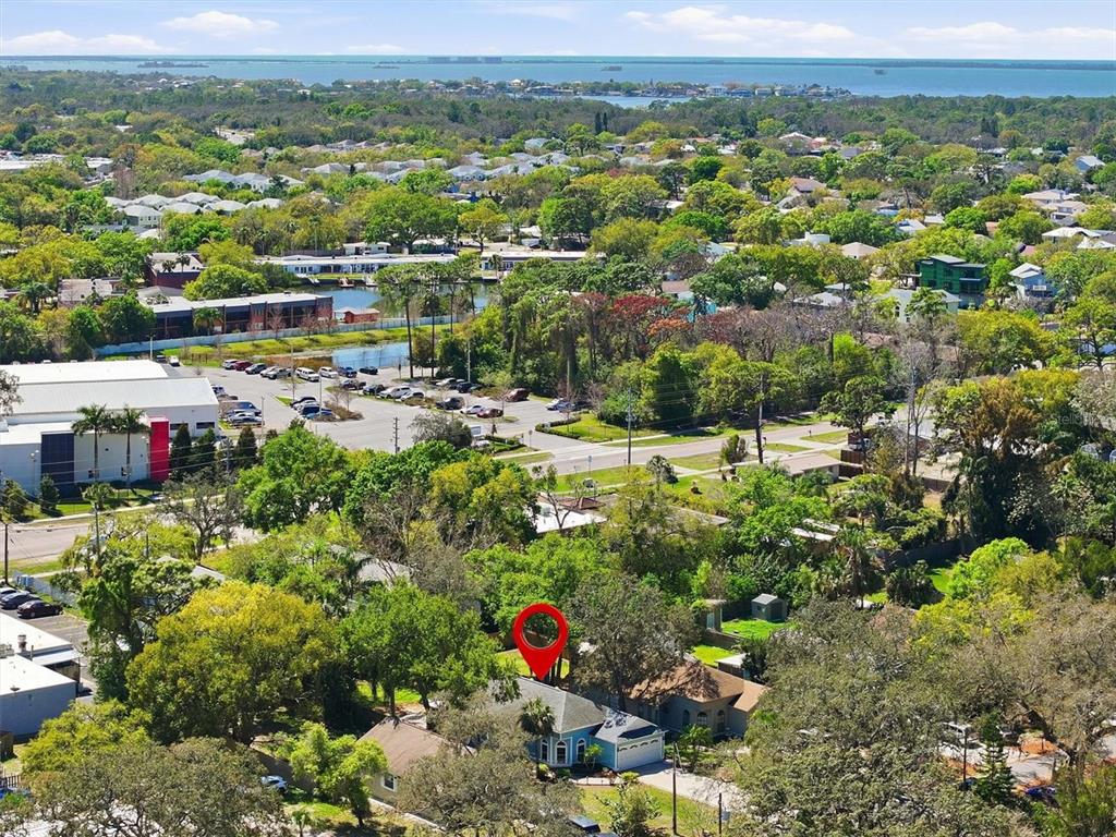 An aerial view shows a single-story house with a red location pin above it — 86 HIGHLAND ROAD, TARPON SPRINGS, FL