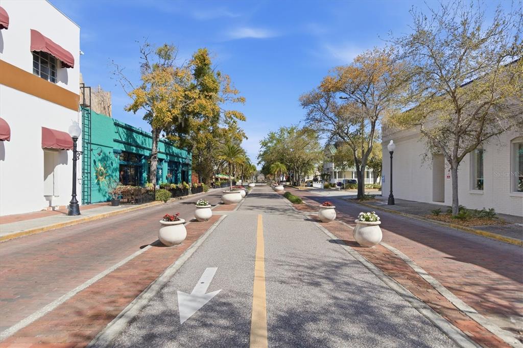 A brick-paved street lined with planters and buildings under a clear blue sky — 86 HIGHLAND ROAD, TARPON SPRINGS, FL