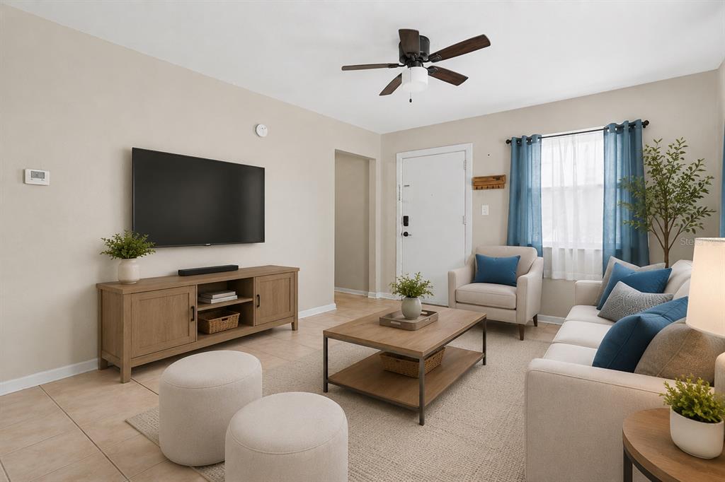 A living room features a television, media console, sofa, armchairs, and a coffee table — 1946 15TH AVENUE S, ST PETERSBURG, FL