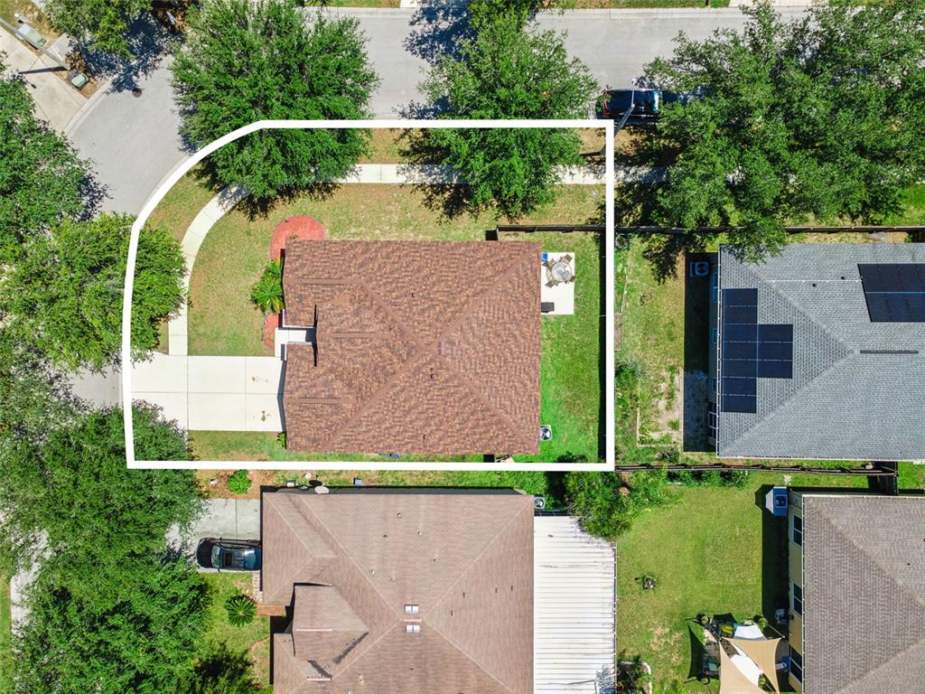This aerial view shows a residential house with a brown roof and a corner lot — 725 STAR POINTE DRIVE, SEFFNER, FL