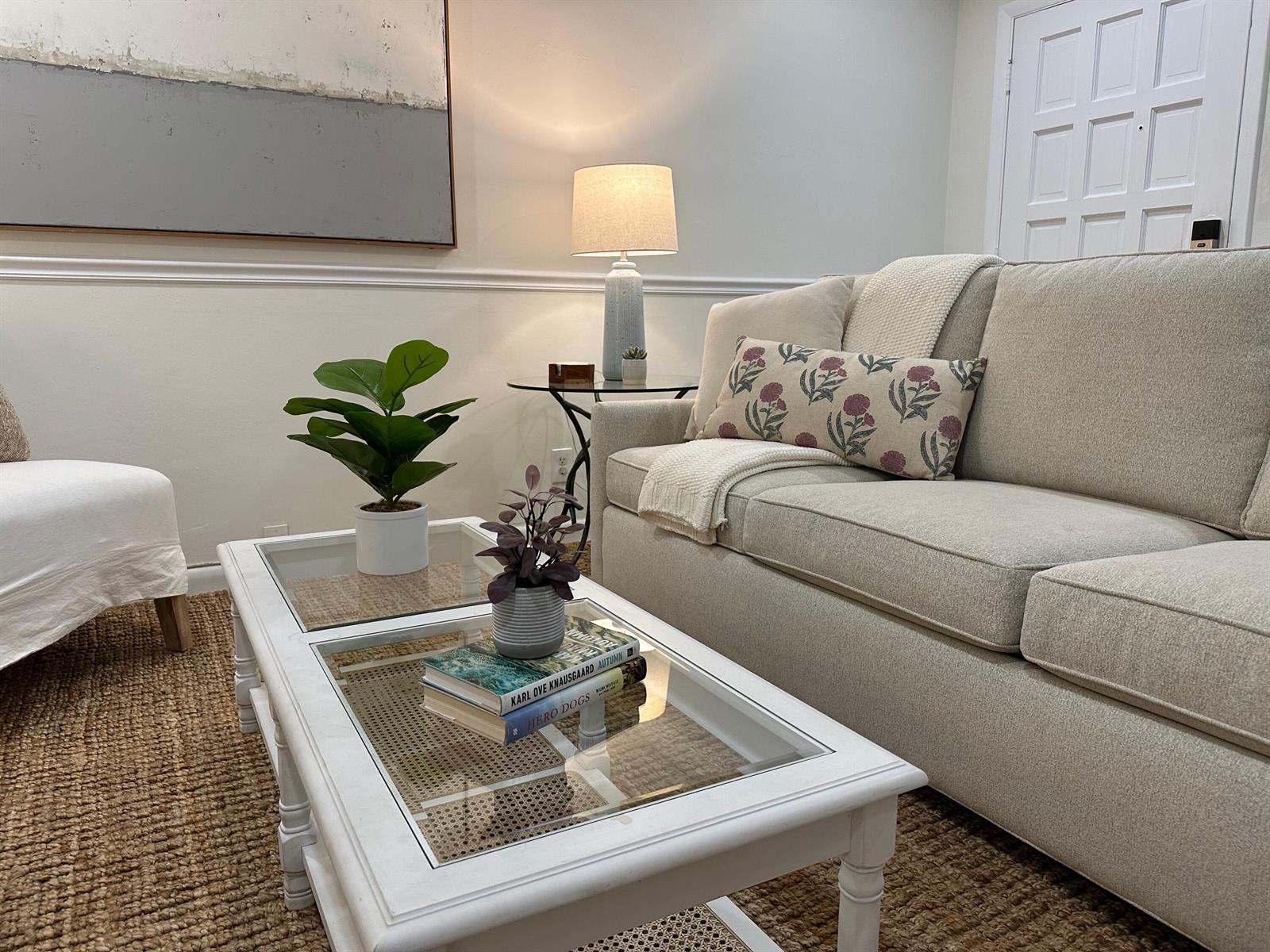A living room features a beige sofa, a white coffee table, and a side table — 1202 Palm Trail # 6, Delray Beach FL 33483, DELRAY BEACH, FL