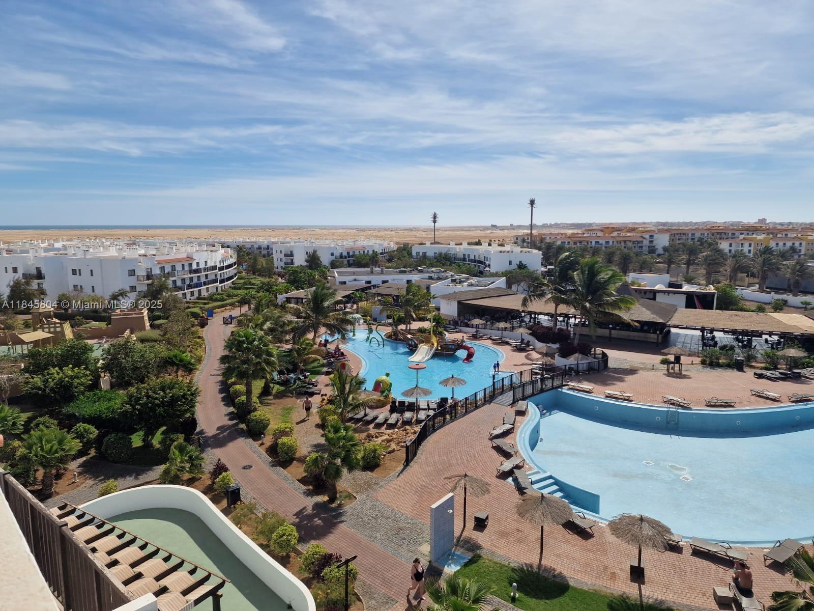 An elevated view of a resort complex featuring multiple swimming pools and surrounding buildings — 4110 Rua Andrade Corvo # 6087, FL, FL