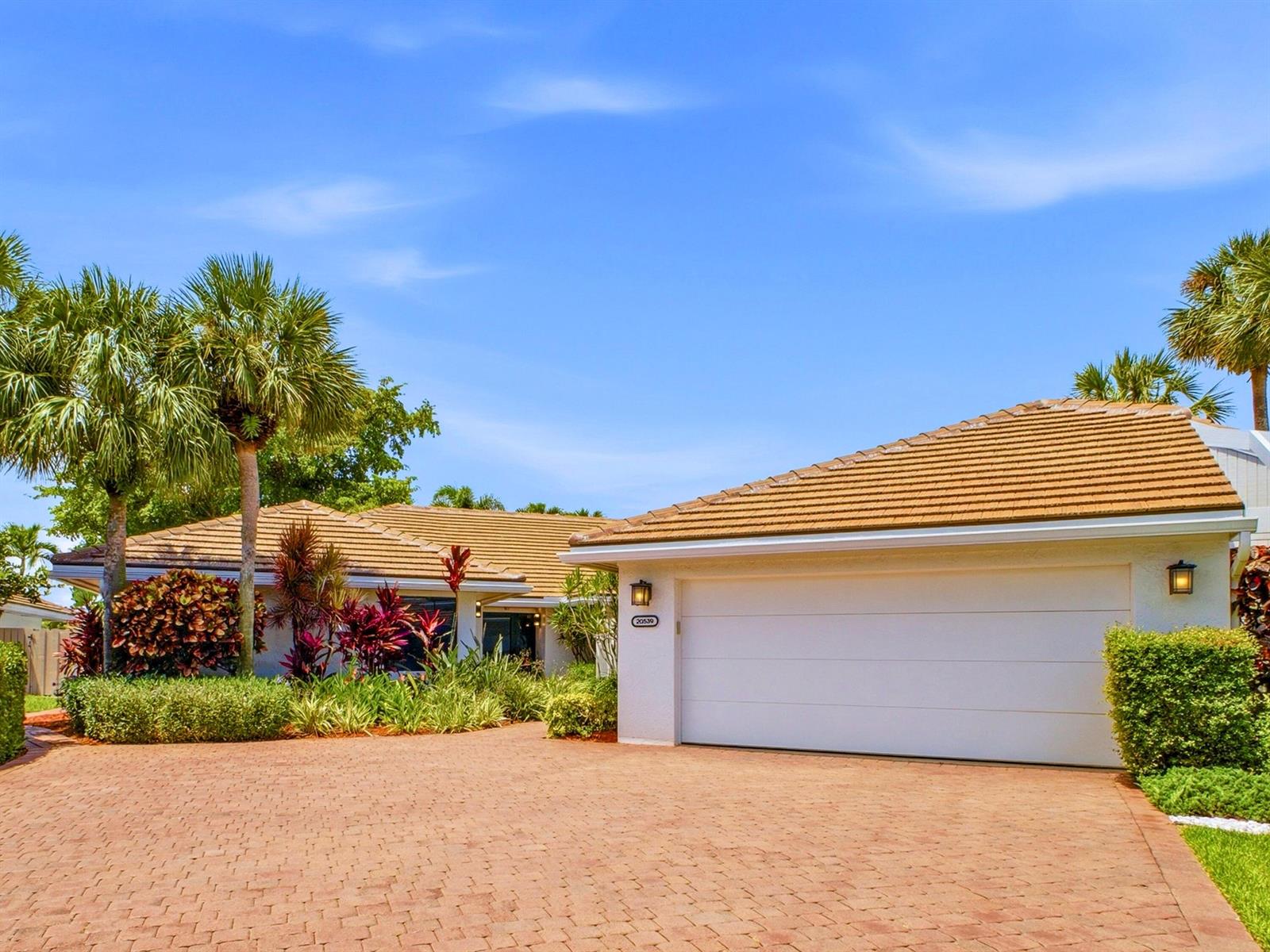 A single-story house with a white garage, tiled roof, and a red brick driveway — 20539 Linksview Way, Boca Raton FL 33434, BOCA RATON, FL