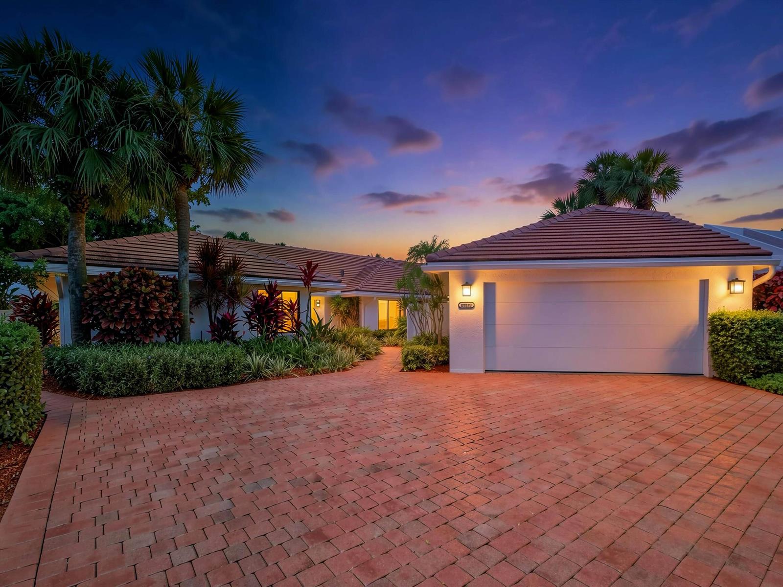 A single-story house with a tiled roof and brick driveway at dusk — 20539 Linksview Way, Boca Raton FL 33434, BOCA RATON, FL