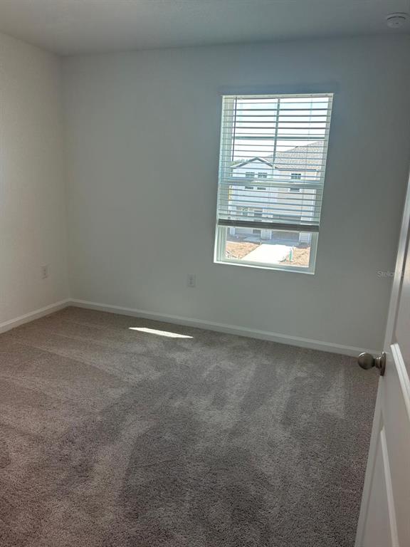 A bathroom features a white vanity, a toilet, and a shower-tub combination with tiled flooring — 3270 VESARA DRIVE, DAVENPORT, FL