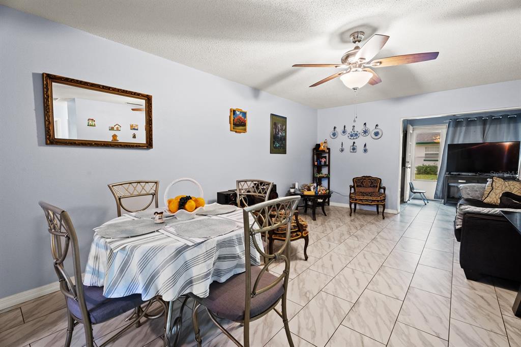 A dining area with a round table, tile flooring, and a ceiling fan — 241 N HILL AVENUE, DELAND, FL