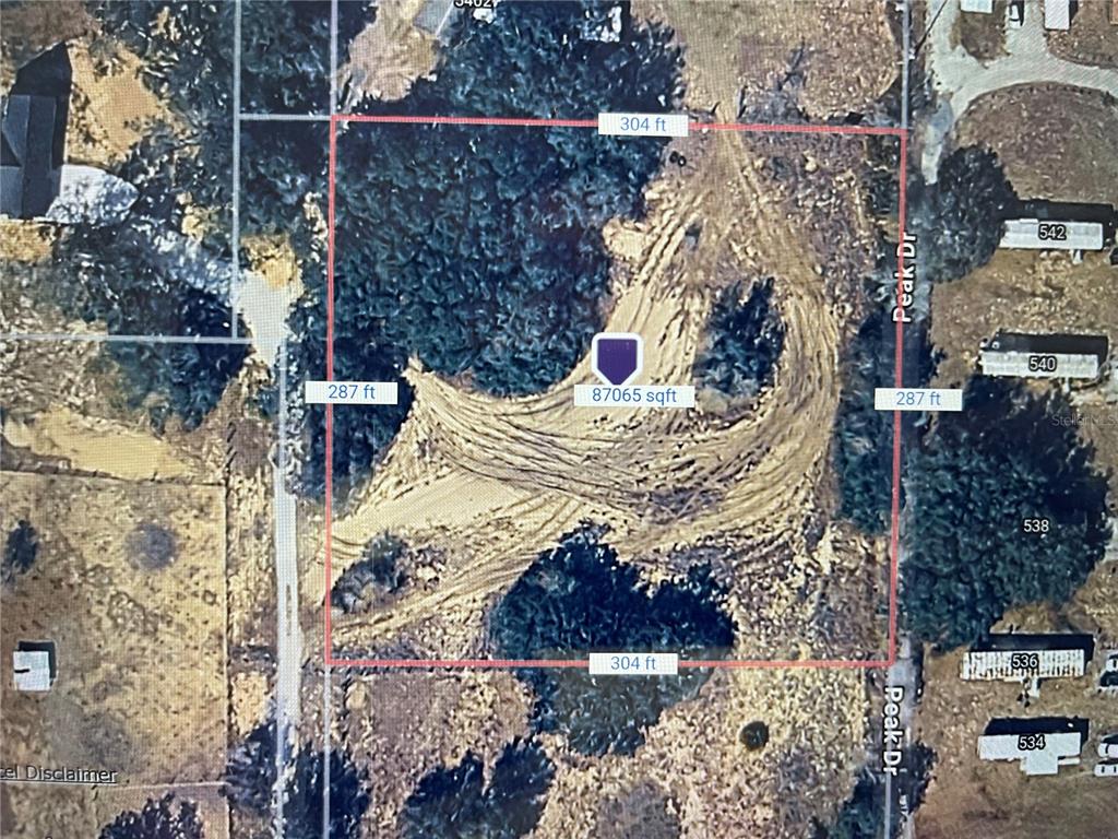 An aerial map shows a rectangular plot of land with dimensions labeled in feet — PEAK DRIVE, HAINES CITY, FL