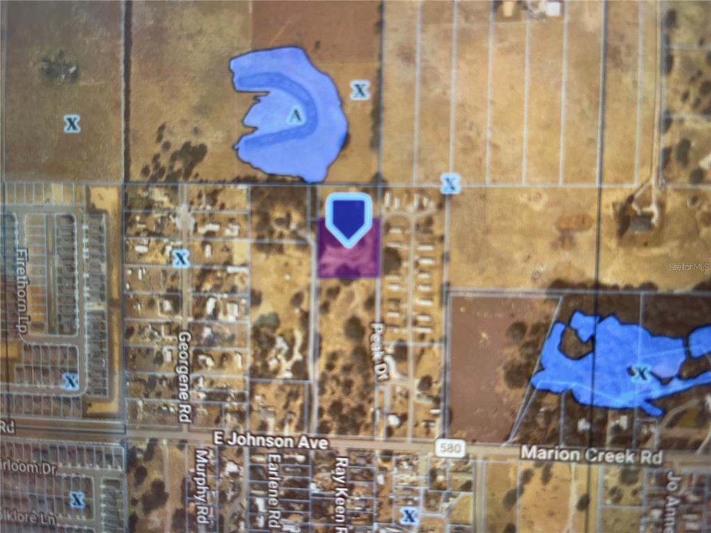 This is a map showing a property location highlighted in purple near several bodies of water — PEAK DRIVE, HAINES CITY, FL