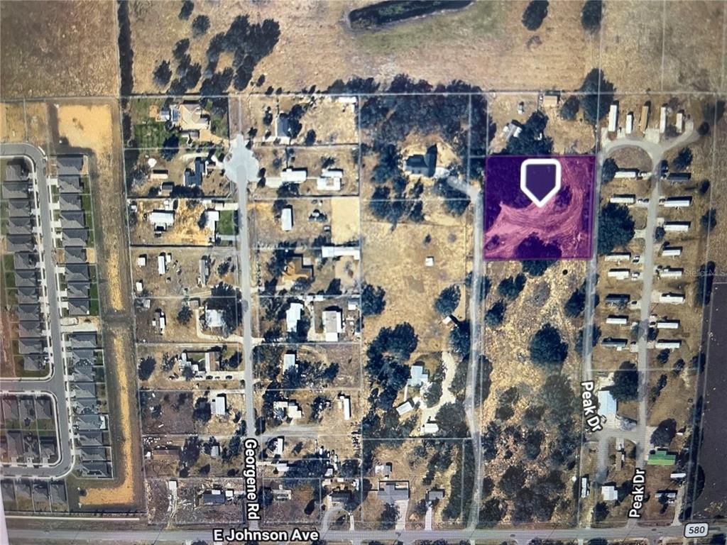 This is an aerial map showing a highlighted vacant lot in a residential area — PEAK DRIVE, HAINES CITY, FL