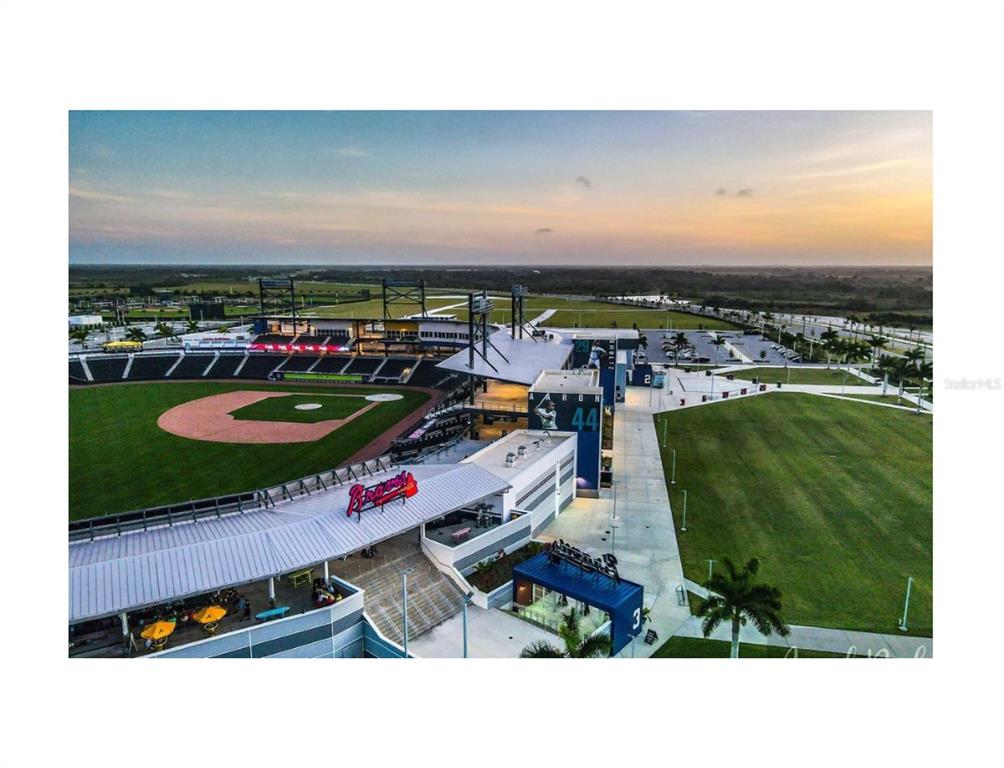 An aerial view of a baseball stadium with a green field and surrounding parking lots — KALSTED STREET, NORTH PORT, FL