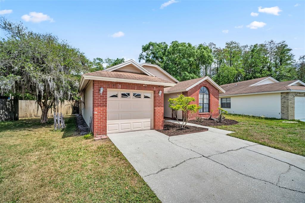 A single-story brick and tan house with a one-car garage and a concrete driveway — 5341 SOUTHWICK DRIVE, TAMPA, FL