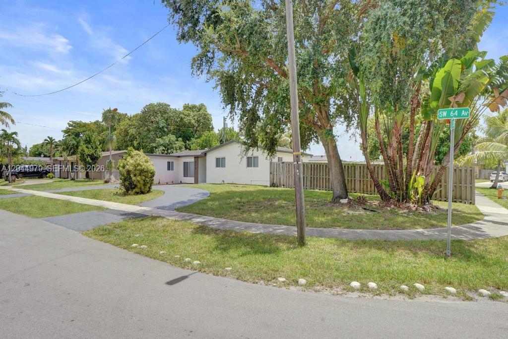 A patio features outdoor furniture, a grill, and wood-slat siding on the exterior wall — 211 SW 64th Ave, Pembroke Pines FL 33023, PEMBROKE PINES, FL