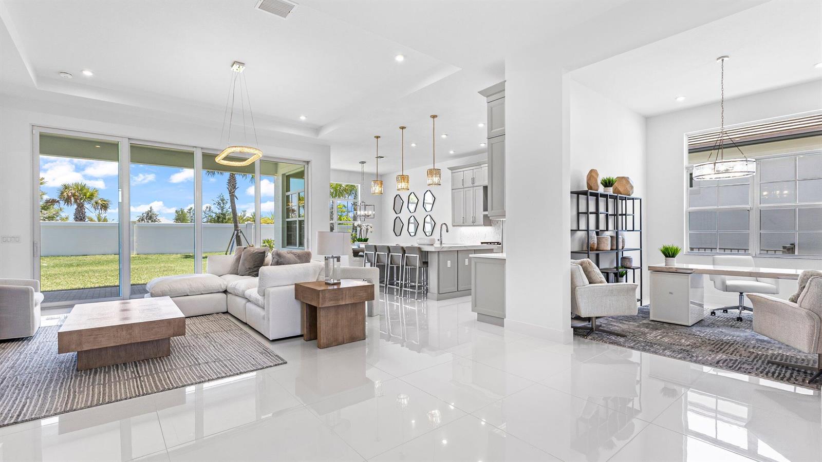 A bright, open-concept living area features white tile floors, a modern kitchen, and sliding doors — 9508 St. Germain, Palm Beach Gardens FL 33412, PALM BEACH GARDENS, FL