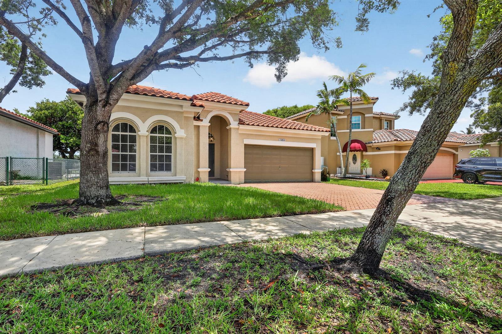 A single-story stucco house with a tile roof, arched windows, and a two-car garage — 13844 SW 53rd Street, Miramar FL 33027, MIRAMAR, FL