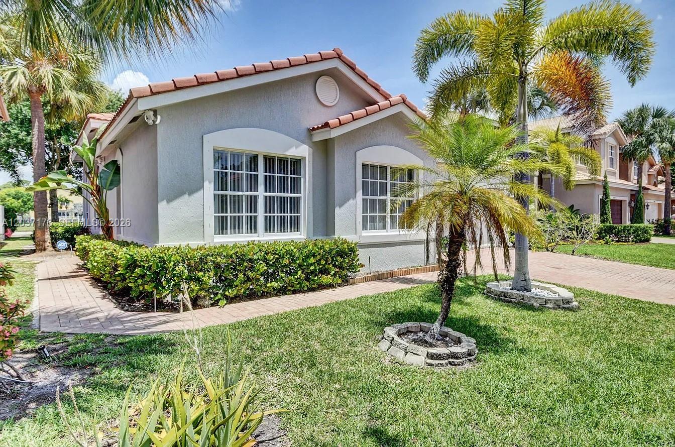 A single-story house with a light gray exterior, a tiled roof, and a palm tree — 12166 COLONY PRESERVE DR, Boynton Beach FL 33436, BOYNTON BEACH, FL