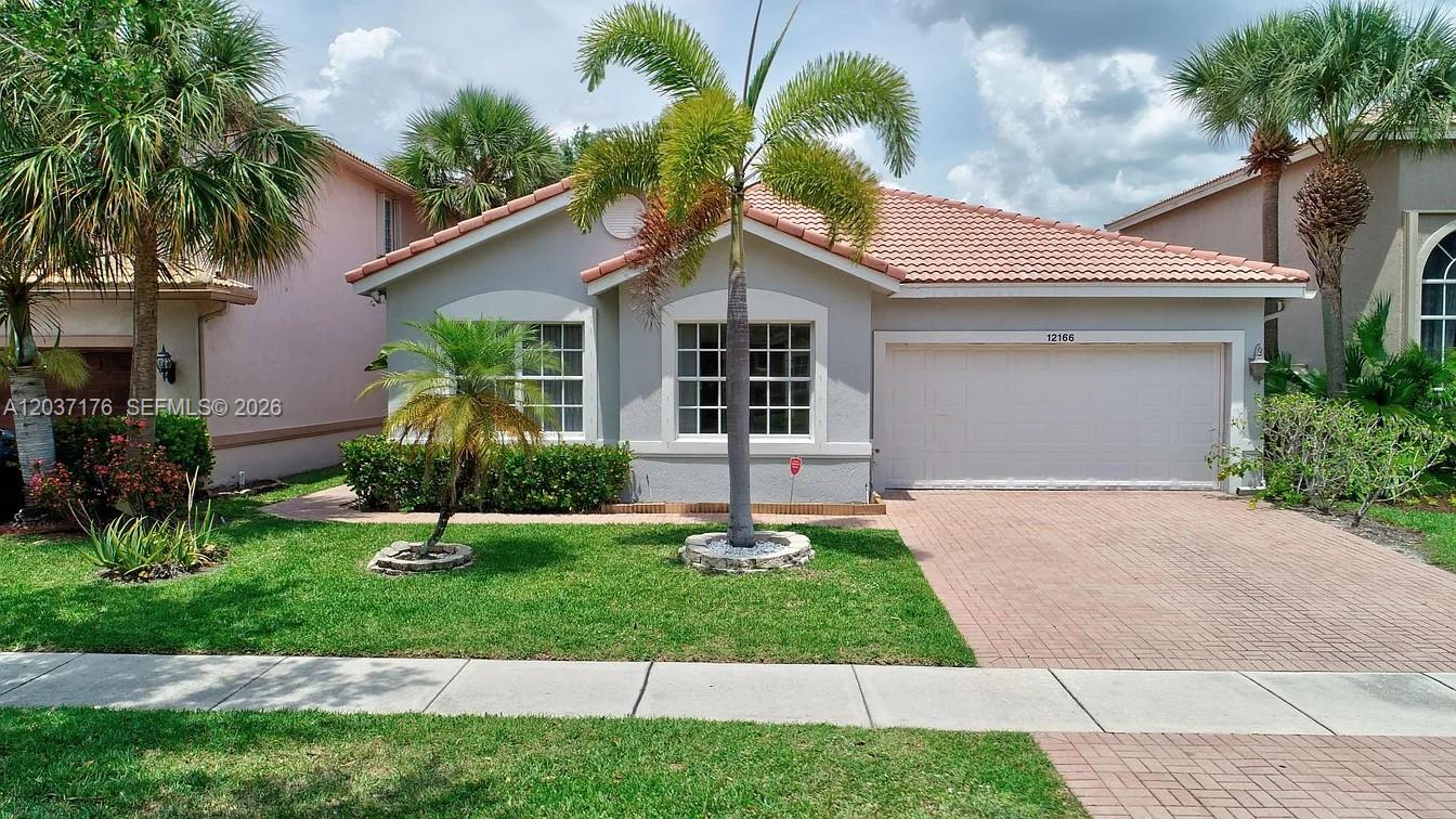 A single-story house with a tiled roof, a two-car garage, and palm trees in front — 12166 COLONY PRESERVE DR, Boynton Beach FL 33436, BOYNTON BEACH, FL