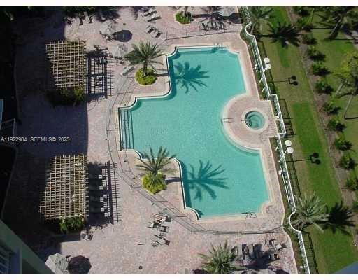 An aerial view of a swimming pool with a hot tub and surrounding patio area — 1755 E Hallandale Beach Blvd # 1005E, Hallandale Beach FL 33009, HALLANDALE BEACH, FL