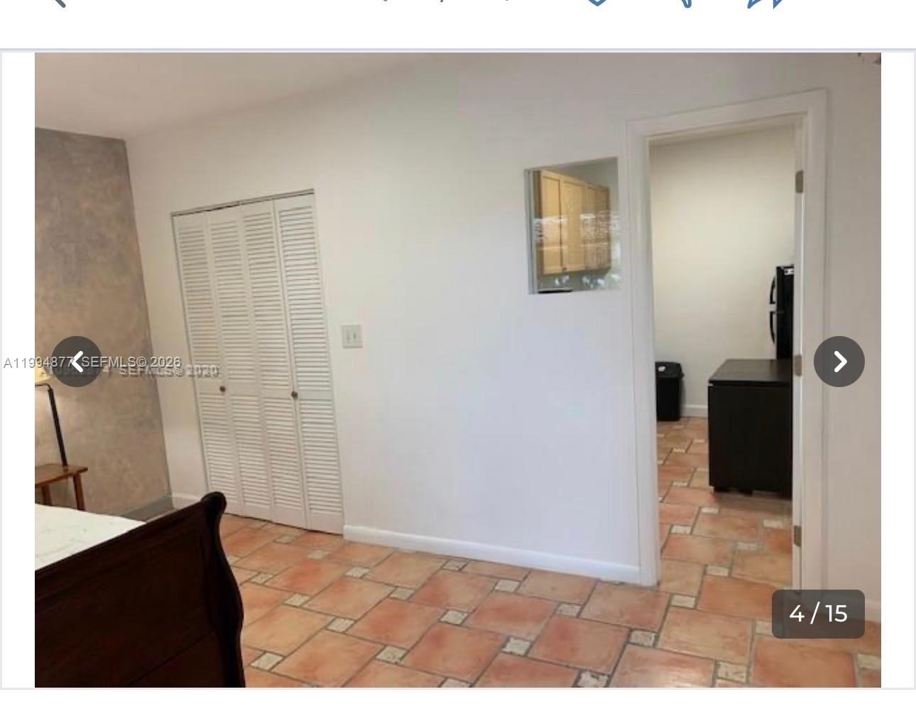 A bedroom with tile flooring, a white closet, and a doorway leading to a kitchen — 4230 SW 11th St # 0, Miami FL 33134, MIAMI, FL