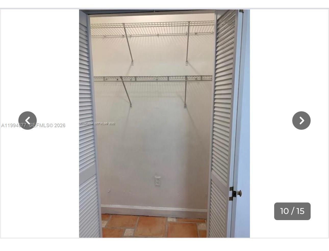 A closet with white louvered doors, wire shelving, and terracotta-style tile flooring — 4230 SW 11th St # 0, Miami FL 33134, MIAMI, FL