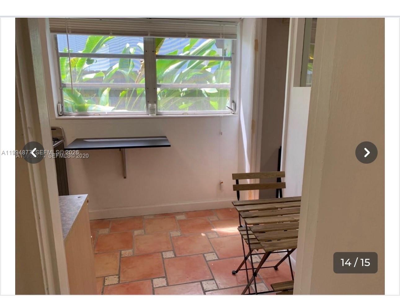 A small room with terracotta tile flooring, a wall-mounted desk, and a folding wooden chair — 4230 SW 11th St # 0, Miami FL 33134, MIAMI, FL